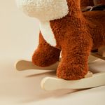 Close-up of fox plush rocker foot and wooden rocking base