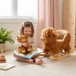 Little girl hugging small highland cow stuffed animal companion next to the wooden rocker