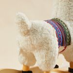 Close-up of soft llama plush rocker fabric and colorful saddle detail