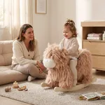 Toddler riding a yak plush rocking horse with parent