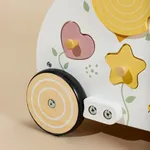 Side view close-up of wooden baby walker showing floral shape sorter and rubber wheels