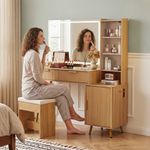Woman using fluted oak vanity desk with lighted mirror and stool in bedroom