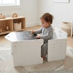 Toddler drawing on white Montessori table and chair set with chalkboard surface