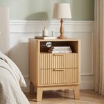 Modern oak nightstand with charging station and bedside storage beside bed
