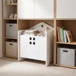 White wooden toddler desk set styled near storage shelf in children room