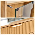 Tempered glass cabinet door and gold handle detail on oak vanity desk