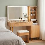 Fluted oak vanity desk with lighted mirror, storage cabinet and stool in modern bedroom