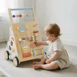 Baby sitting on floor interacting with wooden activity walker learning panel