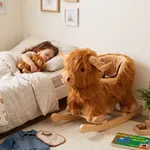 Labebe plush highland cow rocking toy placed beside toddler bed in bedroom