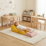 Child relaxing on soft foam climbing blocks in kids playroom