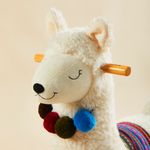 Close-up of llama plush rocker with soft fabric and wooden handle