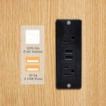 Built-in charging station with USB ports and outlets on vanity desk