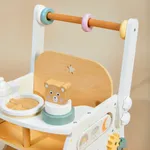 Close-up view of doll seat and play tray with wooden feeding accessories