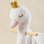 Close-up of white swan plush rocker with crown and wooden handle