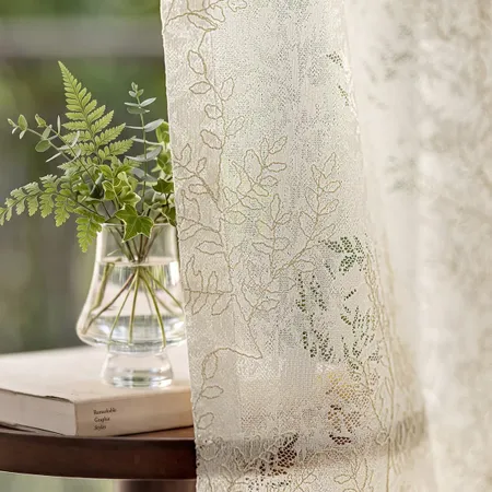 Bloombrook sheer curtains feature a delicate openwork botanical pattern, with layered textures evoking lush branches in full bloom