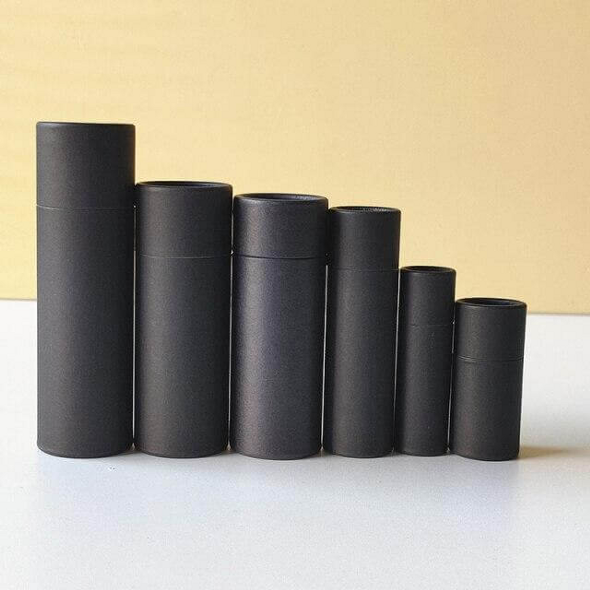 Black lip balm tubes in different sizes