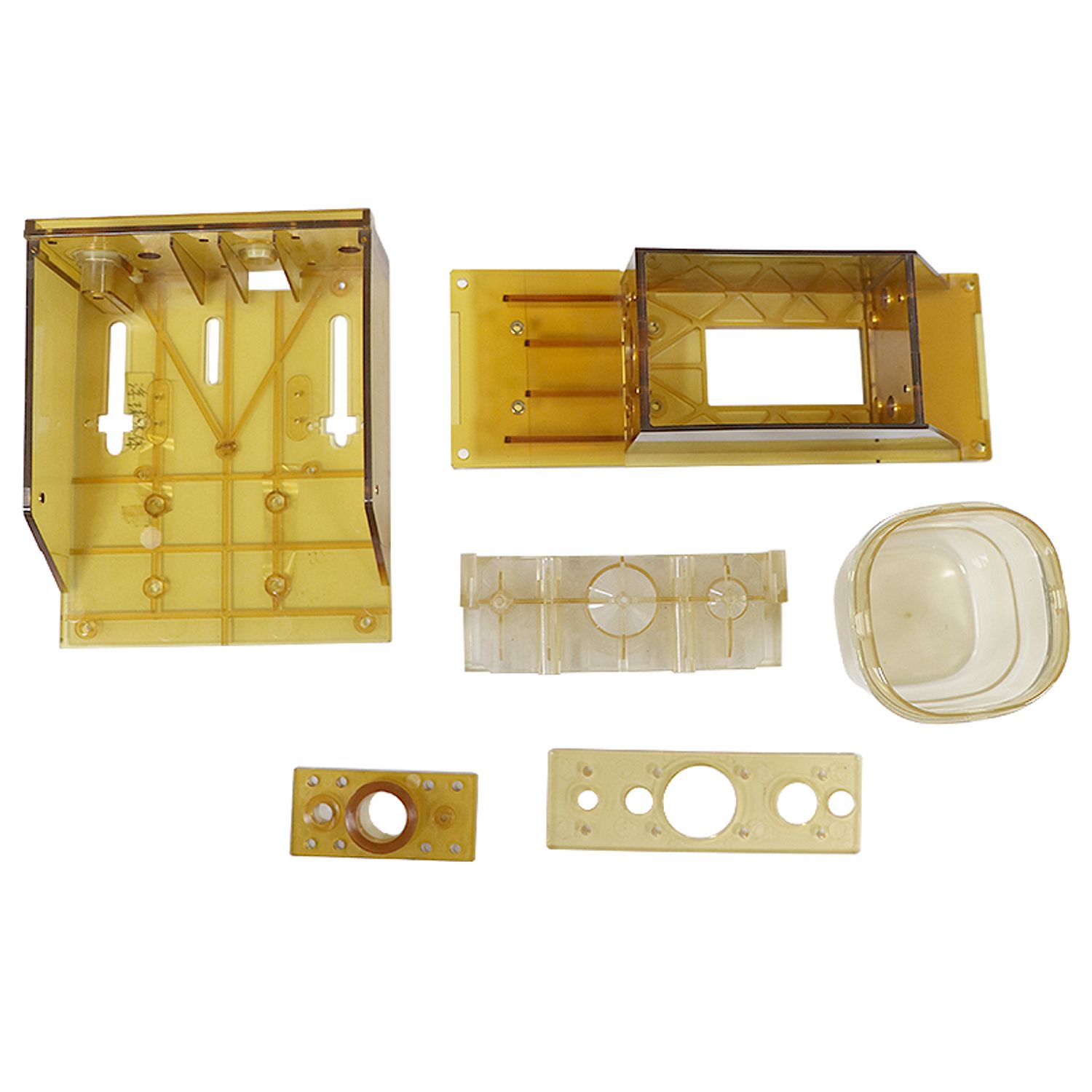 Transparent and amber-colored plastic parts made through SZOMK OEM injection molding, including enclosures and functional components for electronic or medical devices