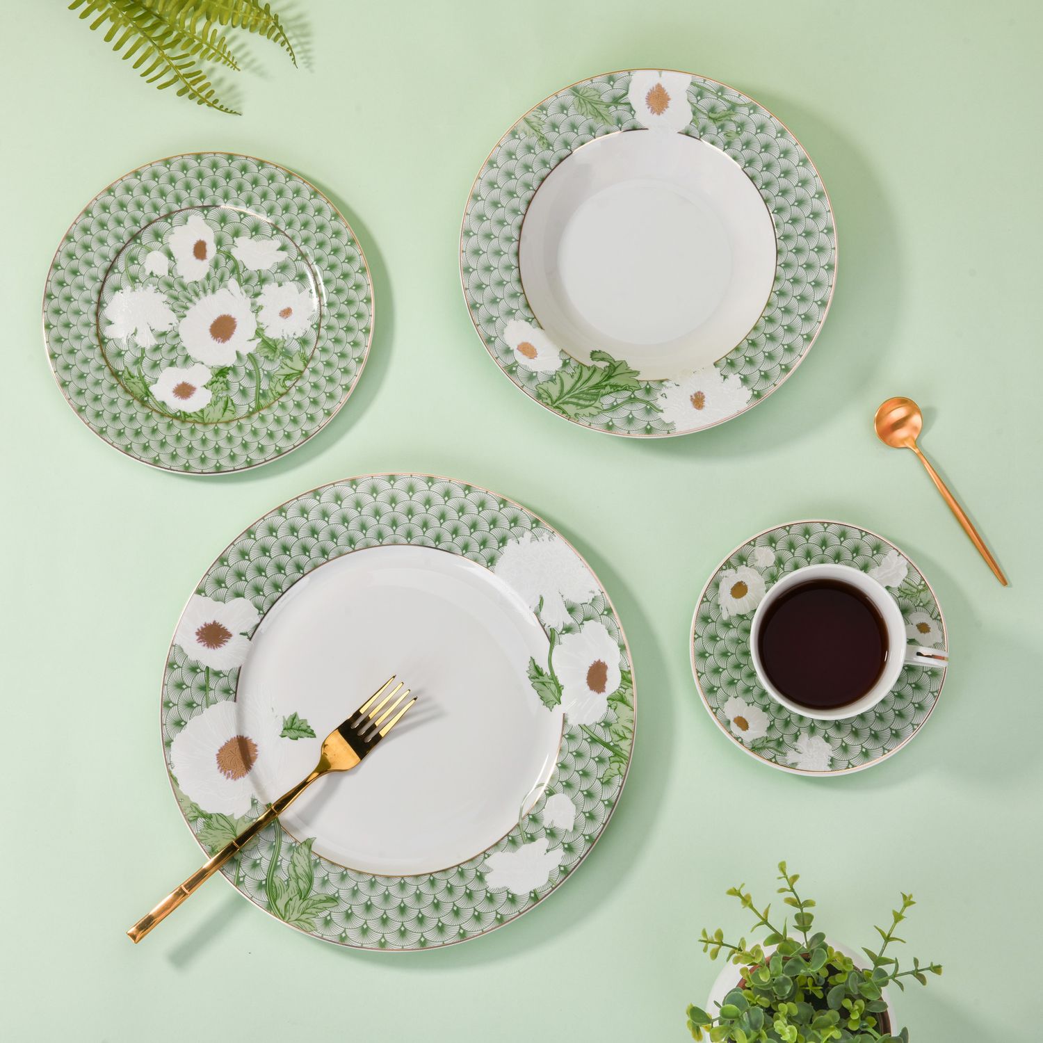 three plates and one cup and saucer in Magnoble Green Blossom Dinner Set with Flower Design