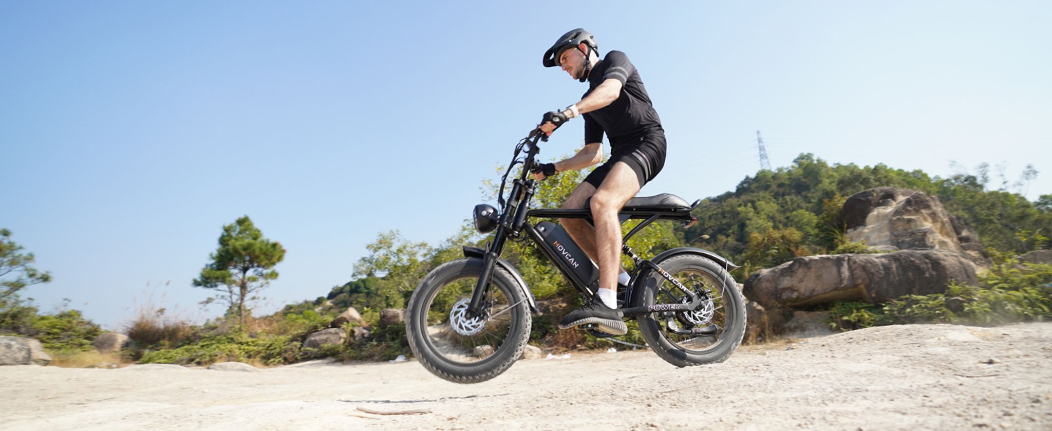A man riding retro style Movcan V60 off-road moutain ebike outside