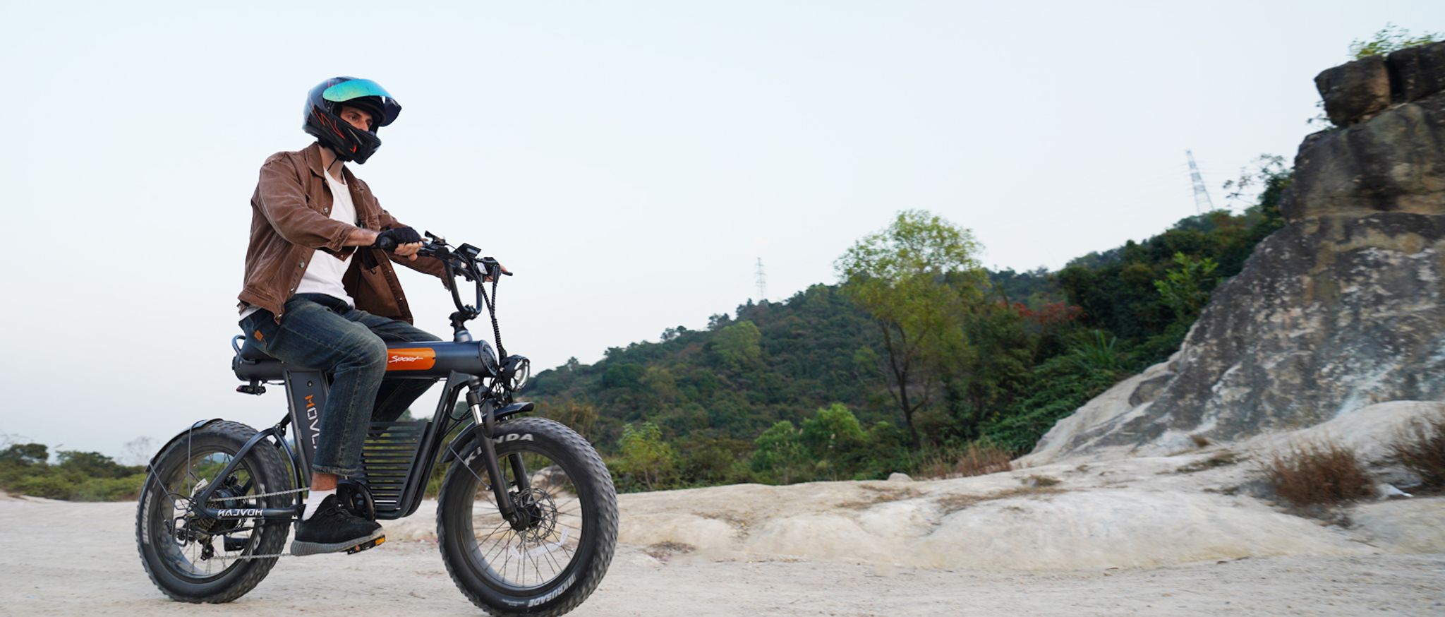 Man Riding MOVCAN V50 Sport Electric Bike on Mountain