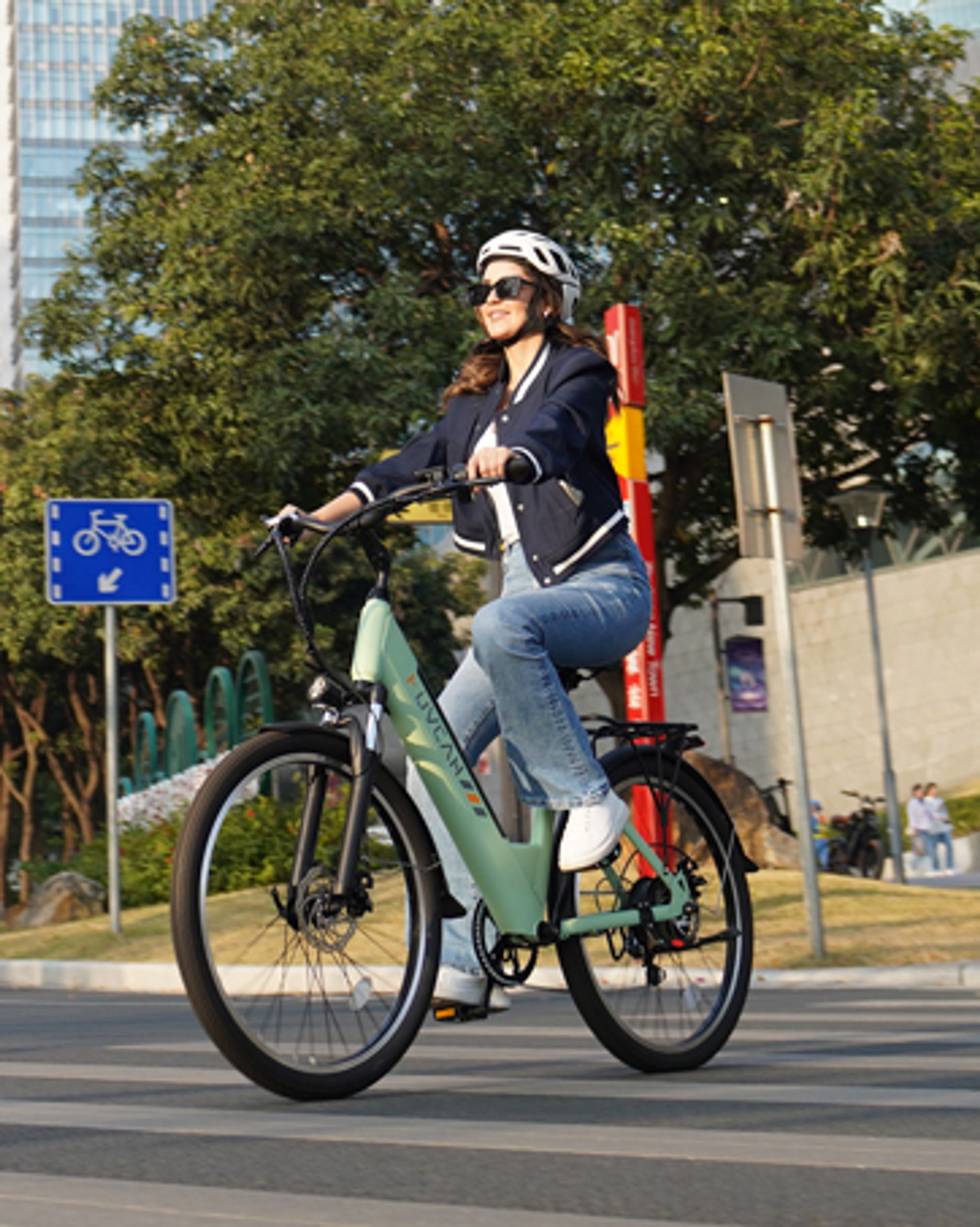 a woman riding an e-bike for commuting on road