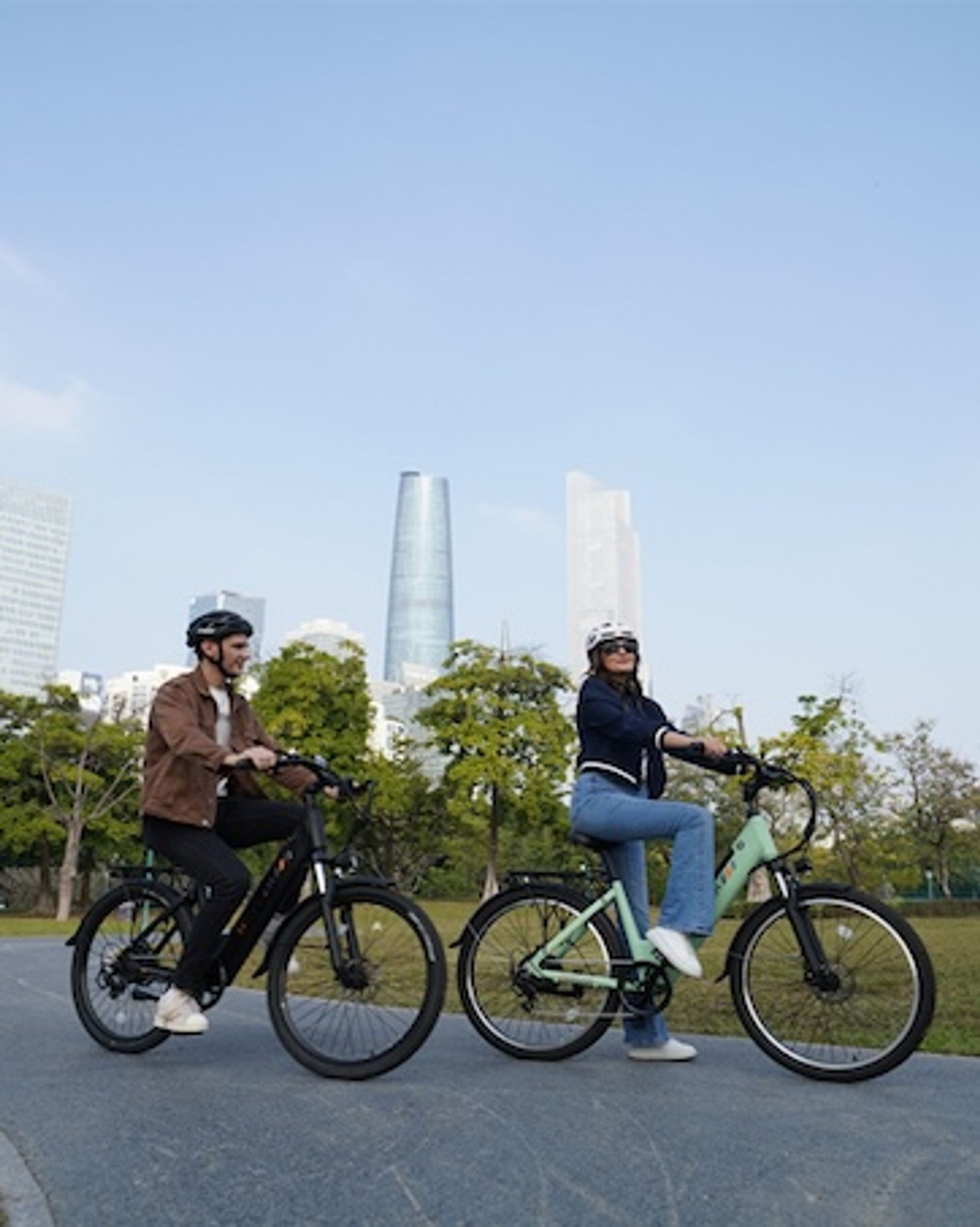 a man and a woman riding Movcan V80 e-bikes for commuting on a city road