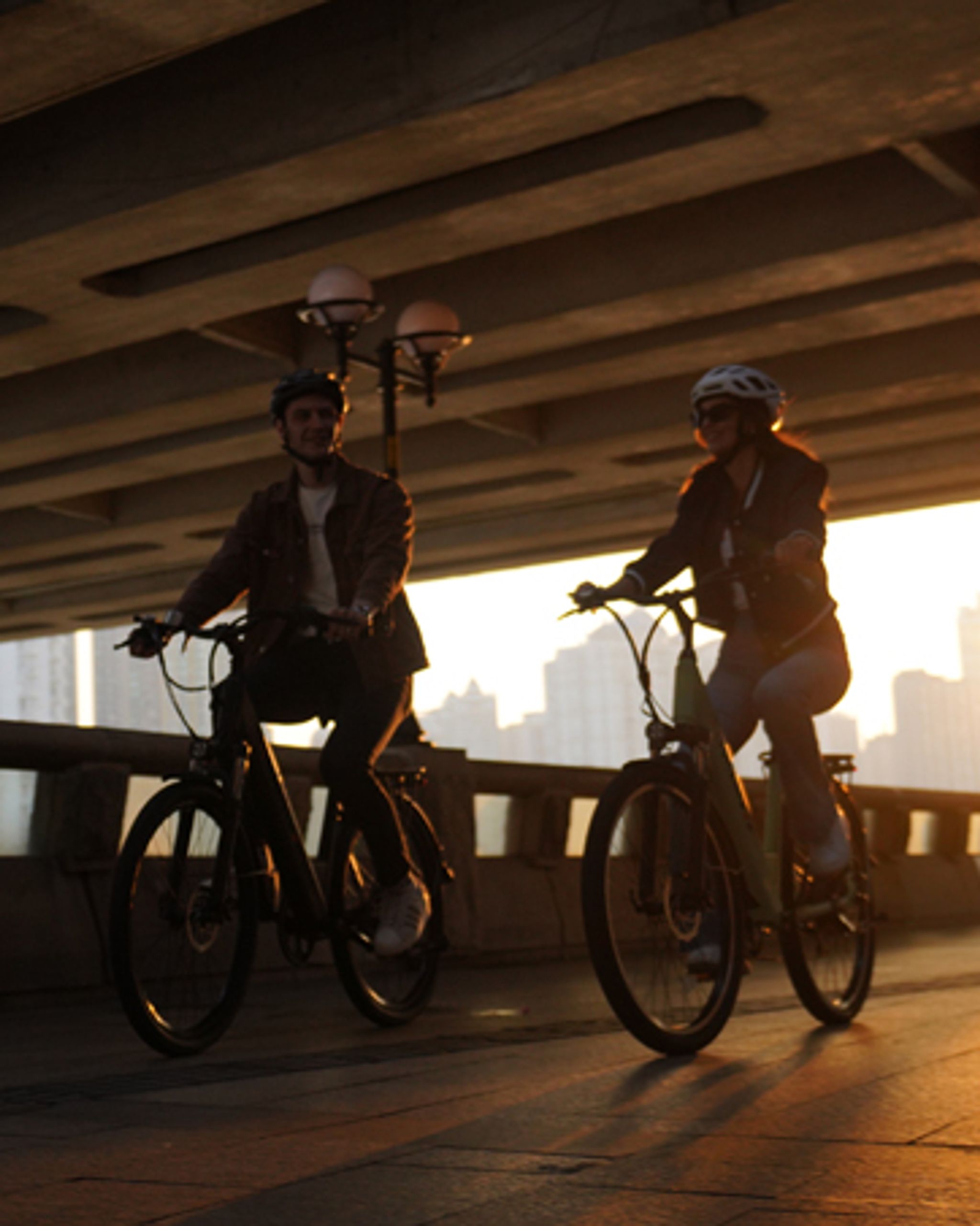 a man and a woman riding Movcan V80 e-bikes for commuting