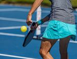 Rotational molded pickleball with a tough, weather-resistant exterior