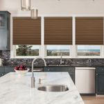 Brown cellular shades in kitchen with marble island and coastal view