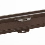 Close-up of brown cordless handle on cellular blind bottom rail